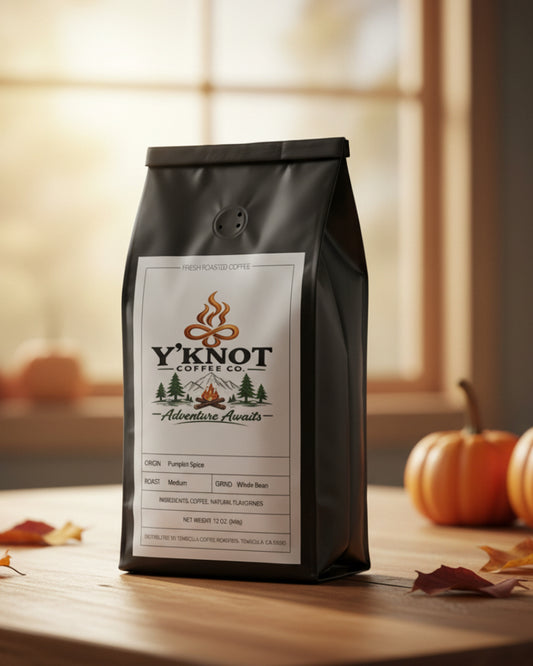 Y’Knot Coffee Co. Pumpkin Spice coffee bag displayed with pumpkins and autumn leaves.